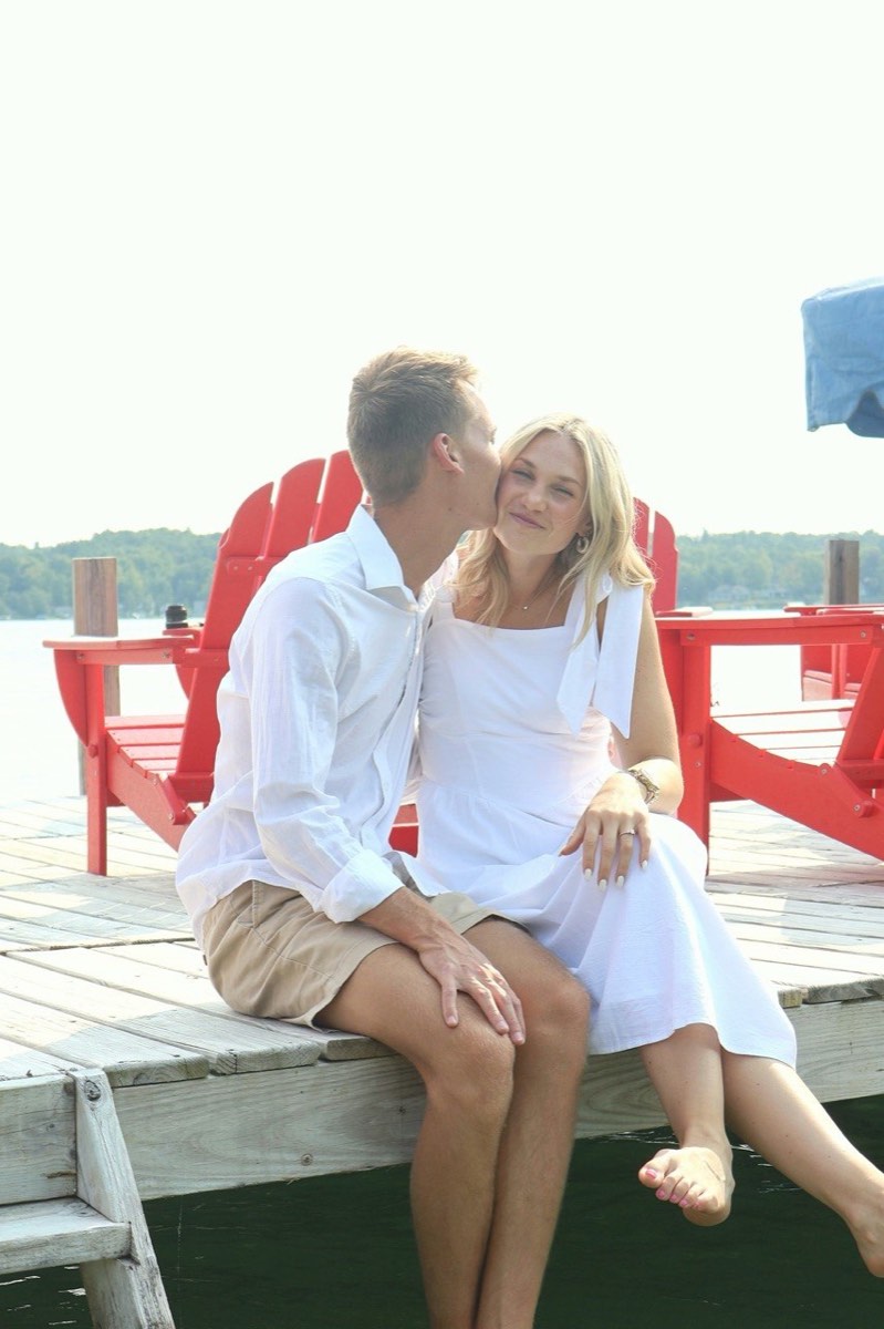 Tucker kissing Syd on the cheek on the dock